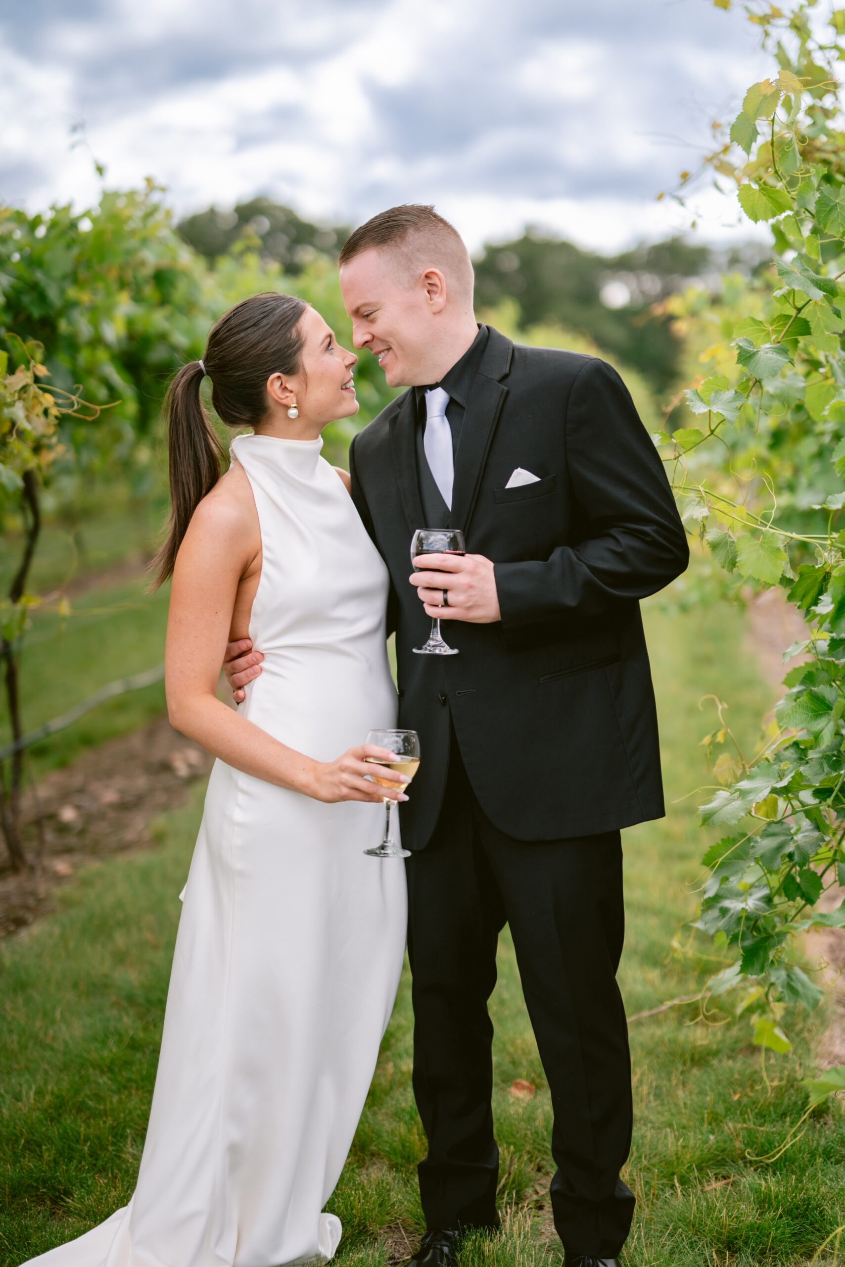Wedding couple in vines at 7 vines vineyard in dellwood, Minnesota